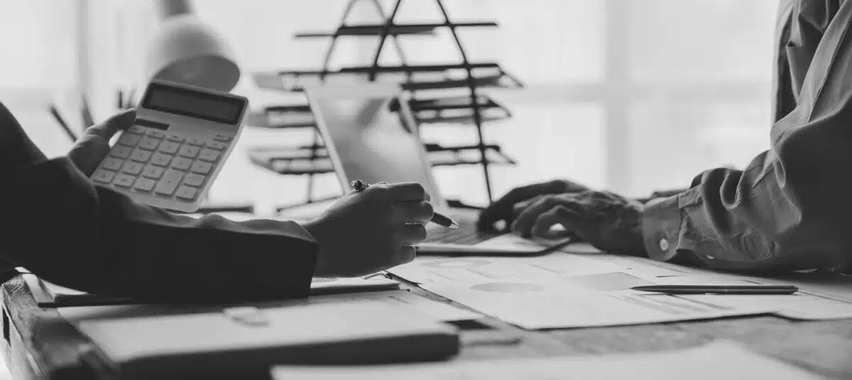 Businessmen and investors gathered together, brainstorming and analyzing financial data | Real estate law, property disputes, commercial real estate