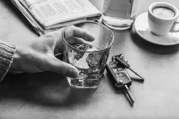Glass of alcohol hand man the keys